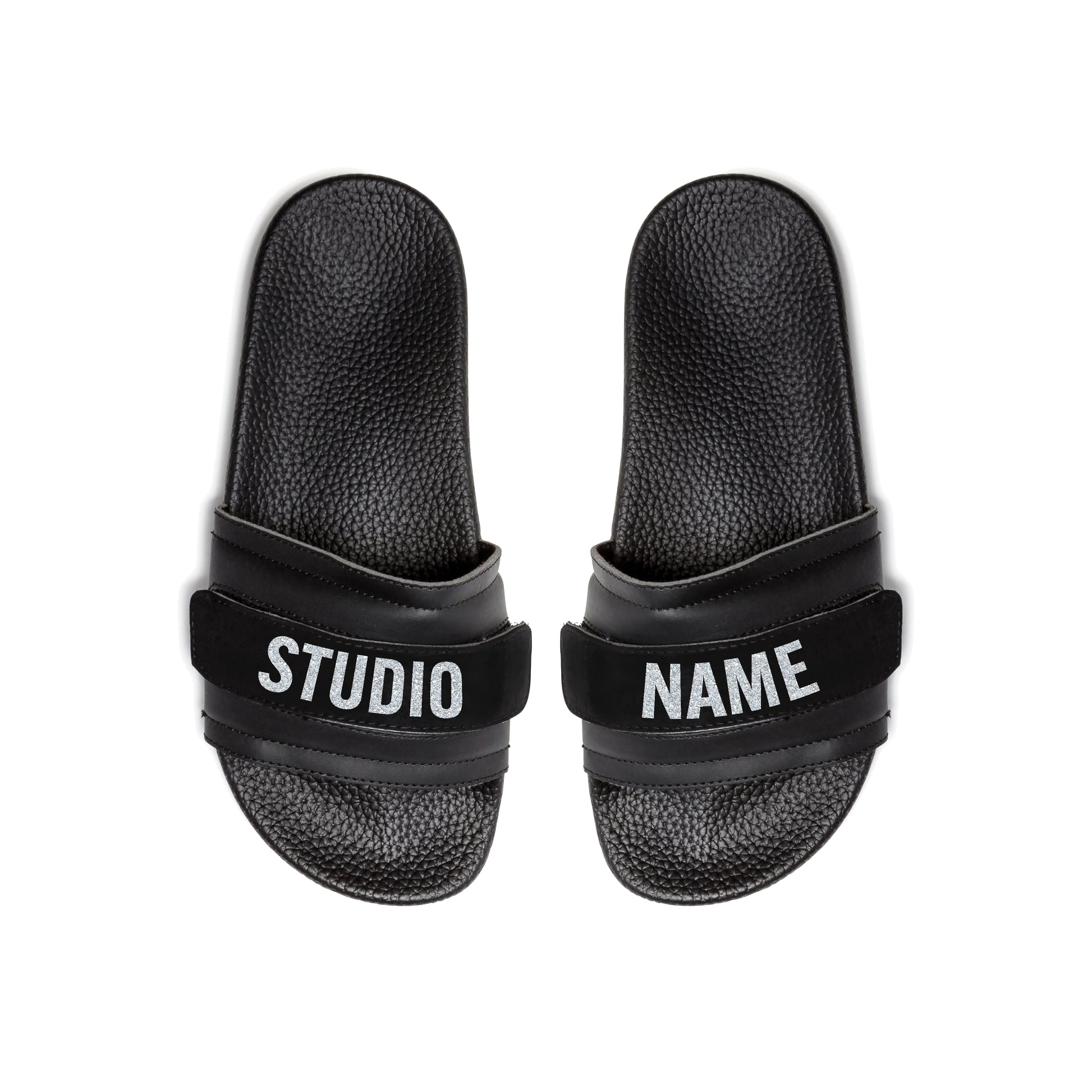 Pair of Pastry Adult Women's Recovery Slide in Black with Studio Name Strap top view