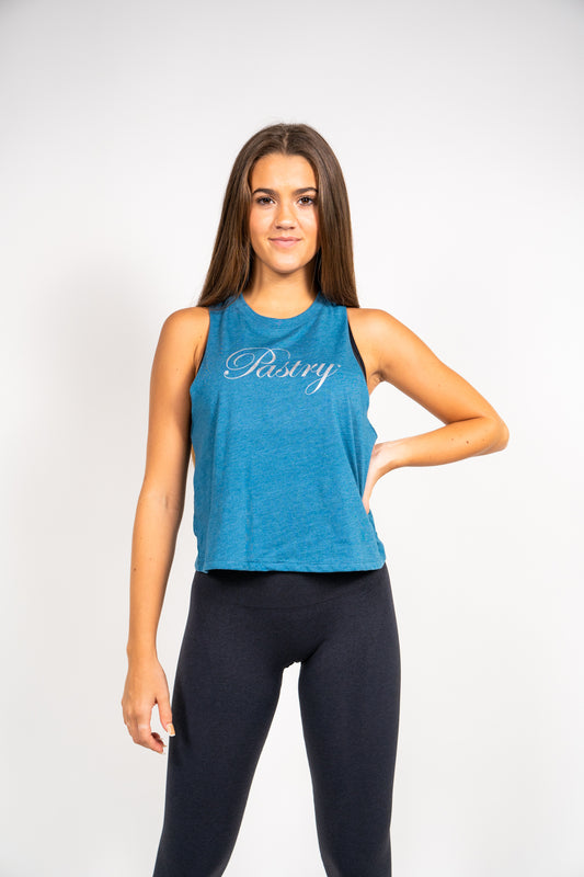 Woman wearing Pastry Cropped Racerback Tank Top Heather Deep Teal with Silver Logo front view