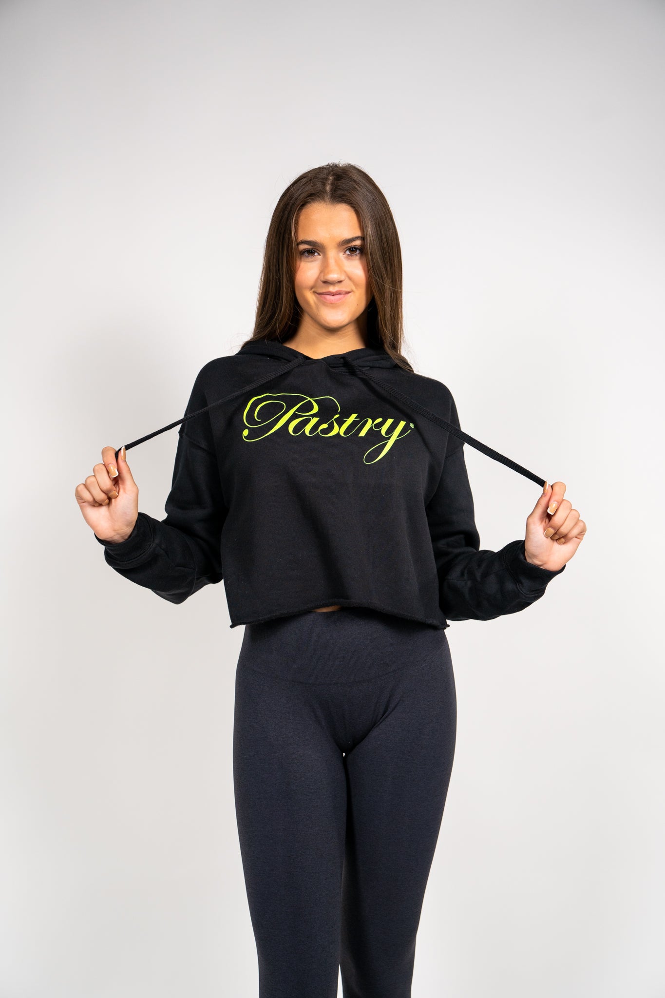 Pastry Cropped Hoodie Black with Neon Green Logo front view