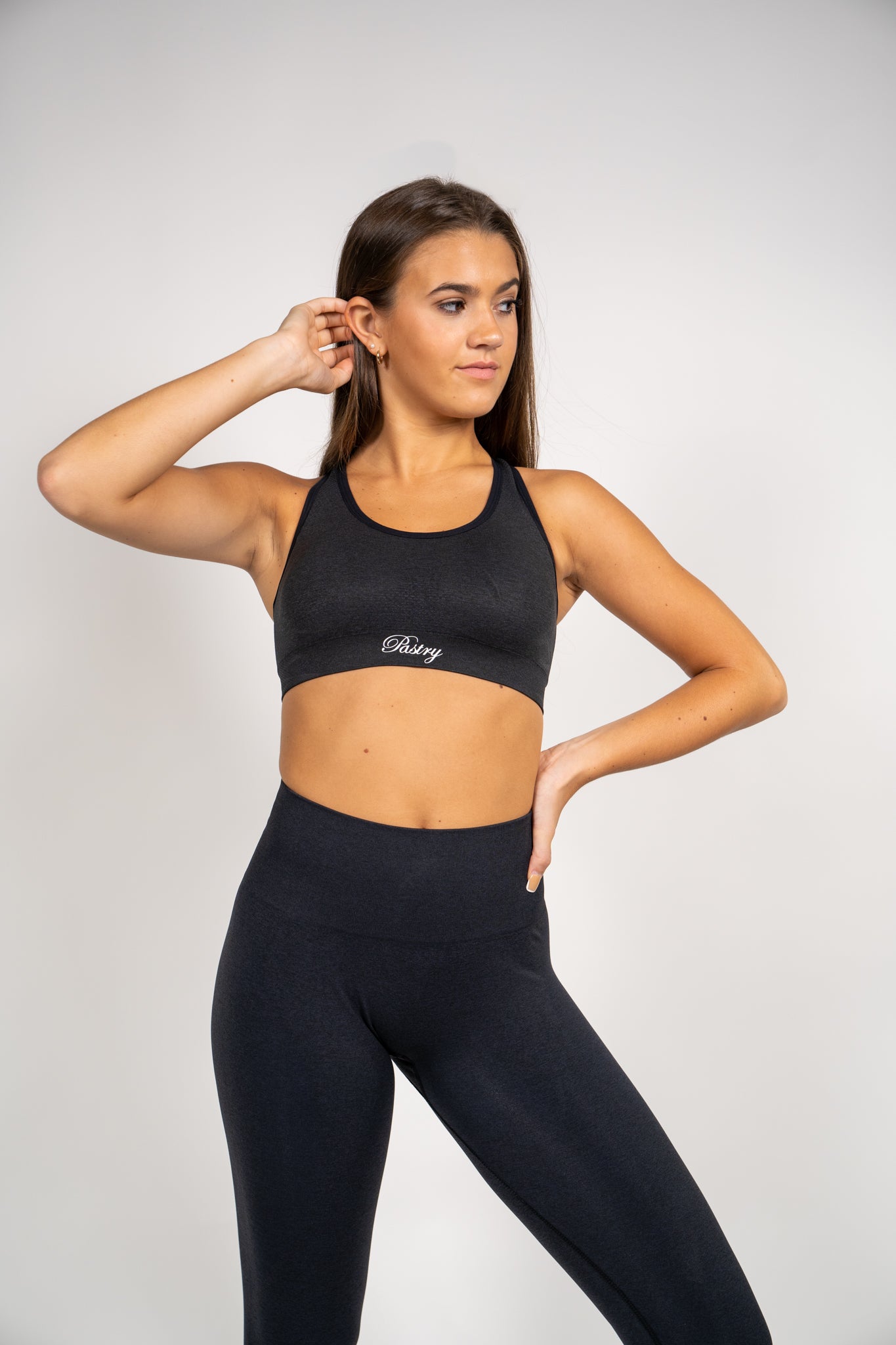 Woman wearing Pastry Seamless Vital Sports Bra Black Marl front view
