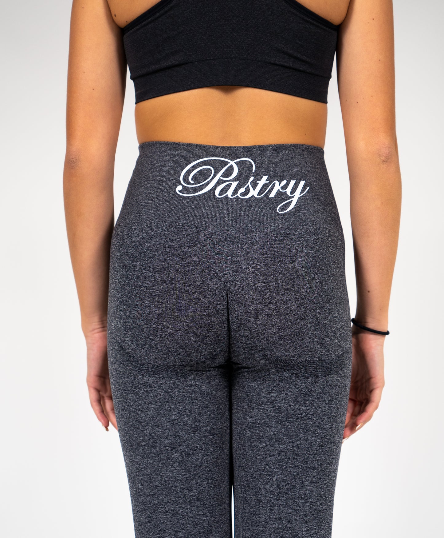 Woman wearing Pastry Seamless Leggings Black Speckled Marl back view