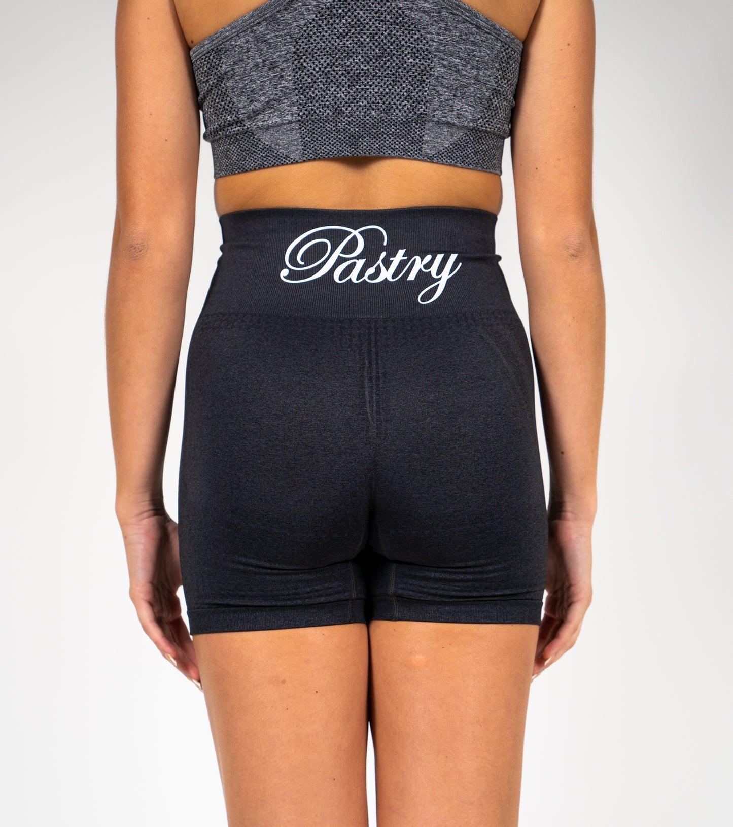 Woman wearing Pastry Seamless High Waisted Shorts Black Marl back view