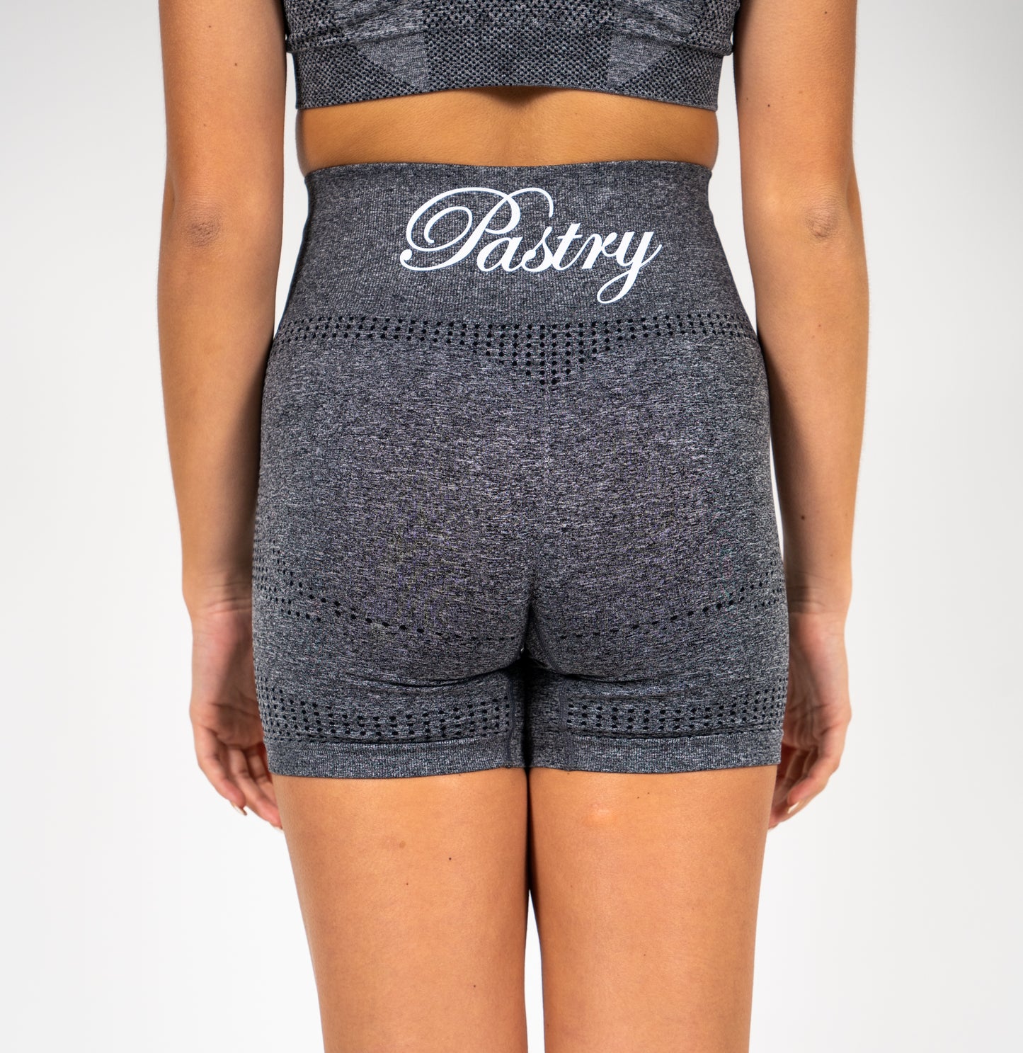 Woman wearing Pastry Seamless High Waisted Shorts Charcoal Grey Marl back view
