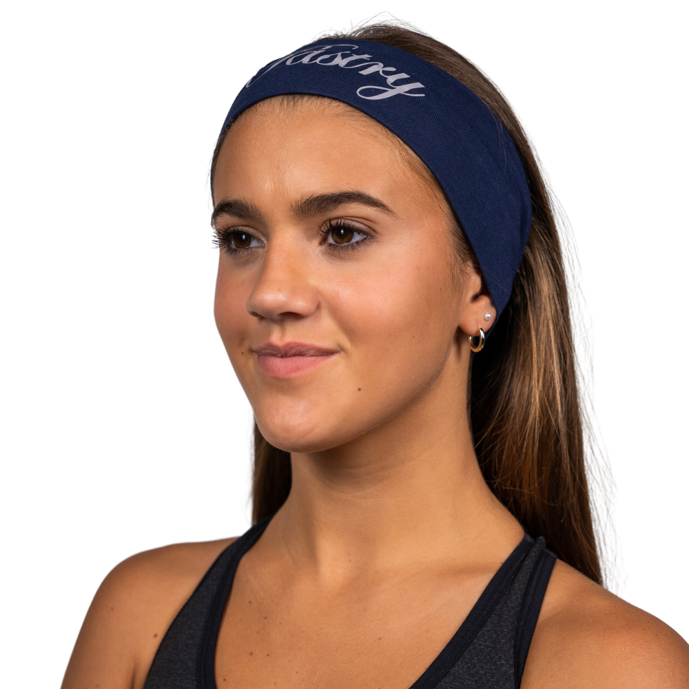 Woman wearing Pastry Spirit Headband with Pastry Silver Logo in Navy Blue